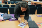 Swati Ravi pointing out details on a quilt square